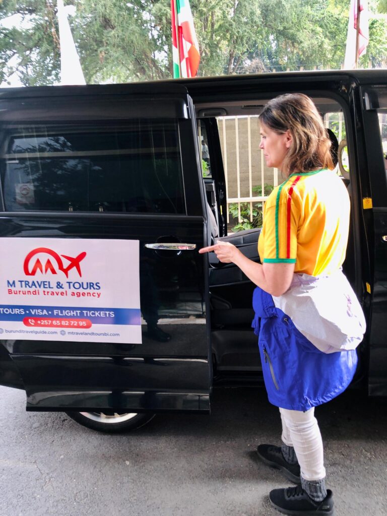 Smiling guests with driver at Bujumbura airport